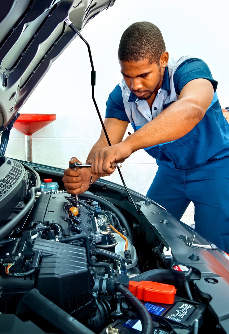 Automotive Technician Works On Car Engine REVISED